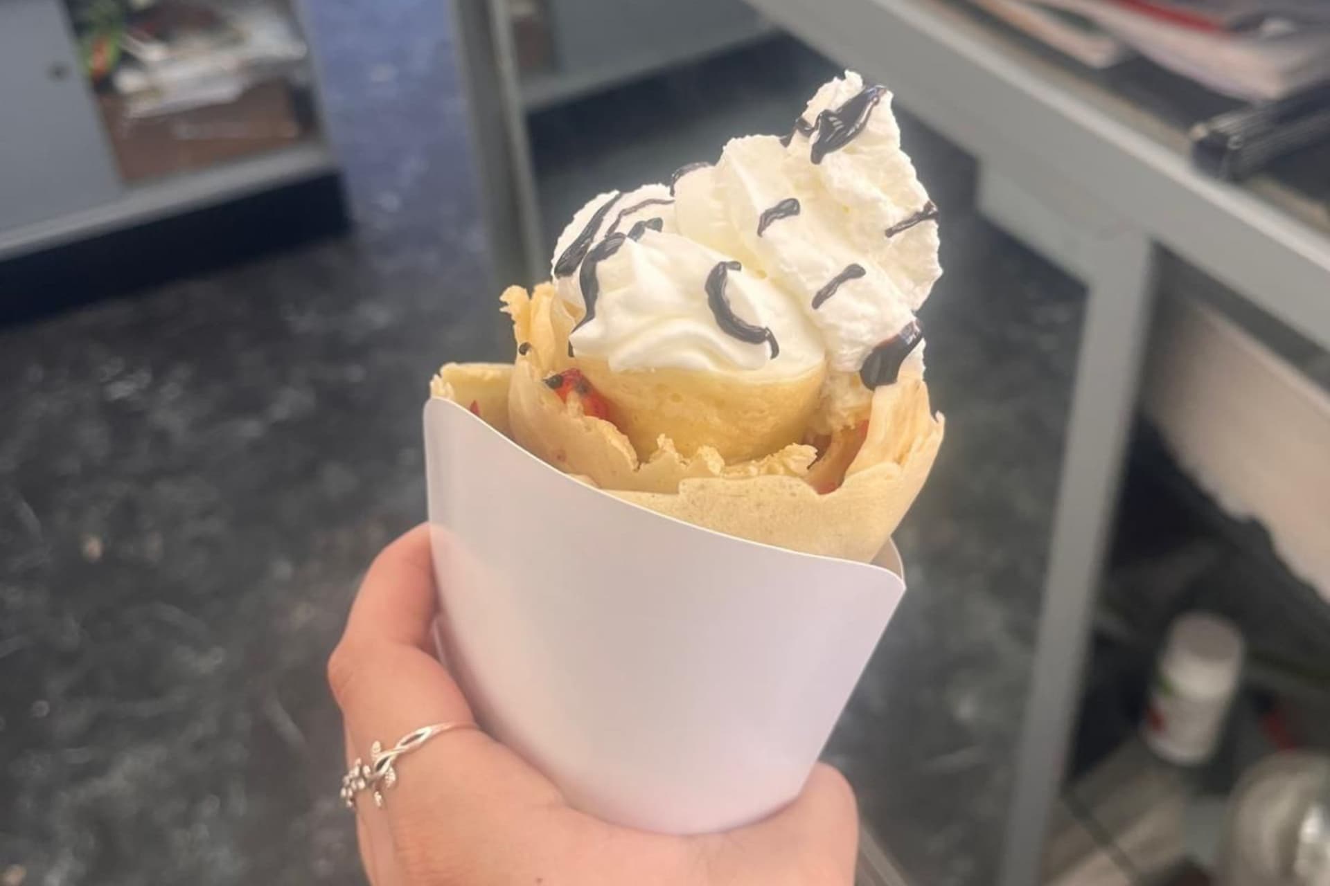 Crepes & Shakes signature crepe cone overflowing with strawberries, banana and Nutella